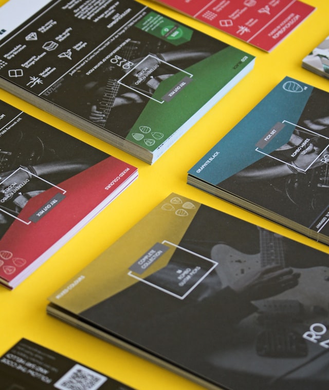 Printed marketing brochures and social media graphics laid out on a table