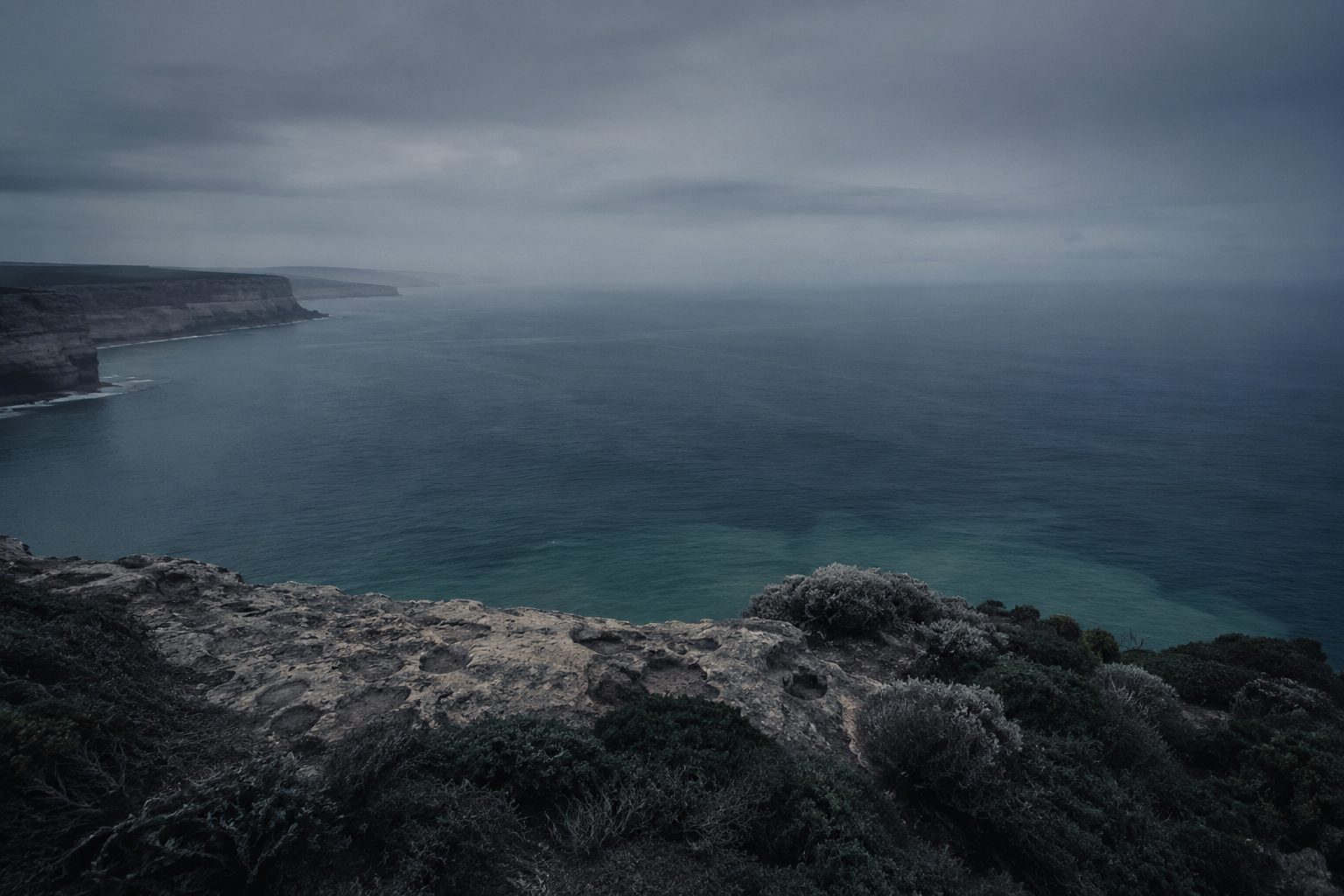 Moody view of rugged cliffs meeting the ocean along South Africa's East Coast near Durban